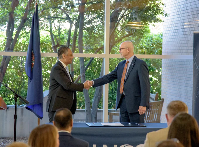 A close-up of two people shaking hands, representing a partnership between NASA and the United Network for Organ Sharing to improve the speed and coordination of organ transport for transplantation.
