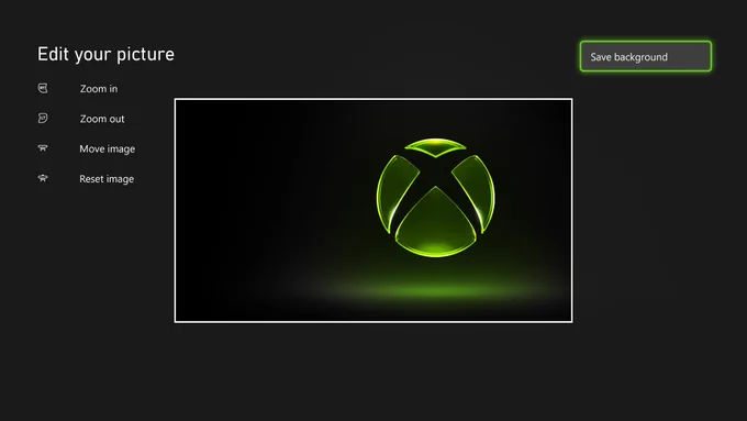 A screenshot of the custom image editor on Xbox. There are controls to zoom in, zoom out, move image, and reset image, as well as a Save background button, which is focused. Inside the bounding box is a slightly offset image of a glowing, green Xbox logo.