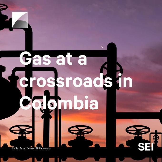Gas pipeline silhouetted against a purple and orange sunset sky with a crescent moon. White text reads, "Gas at a crossroads in Colombia".