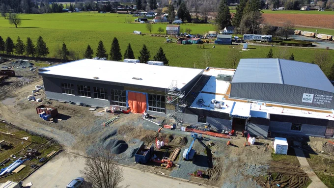 Outdoor aerial shot of the Lets’emot Regional Recreation and Aquatic Centre surrounded by construction. 