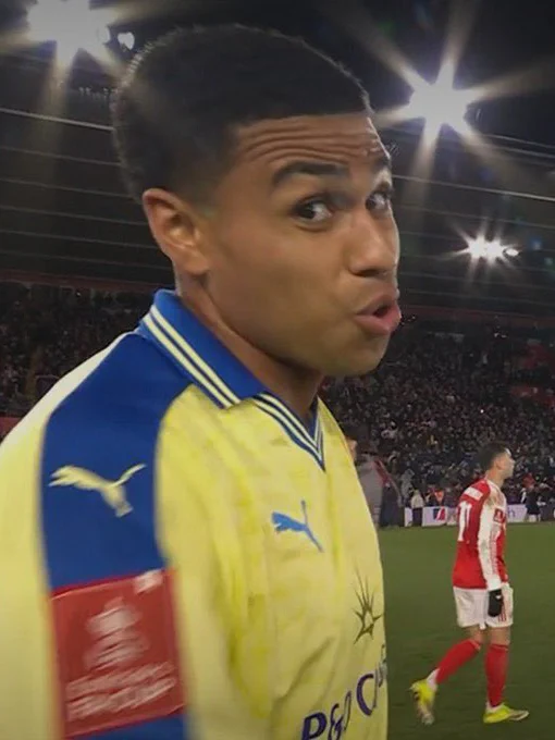 A screenshot of Shea Charles looking at the camera following the full time whistle and puffing his cheeks out.