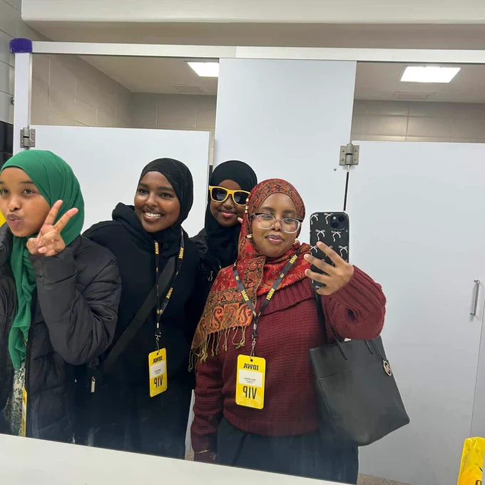 Students taking a mirror selfie with VIP badges.