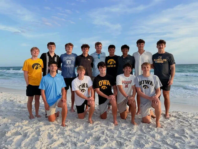 A group of students in Iowa and other school apparel.
