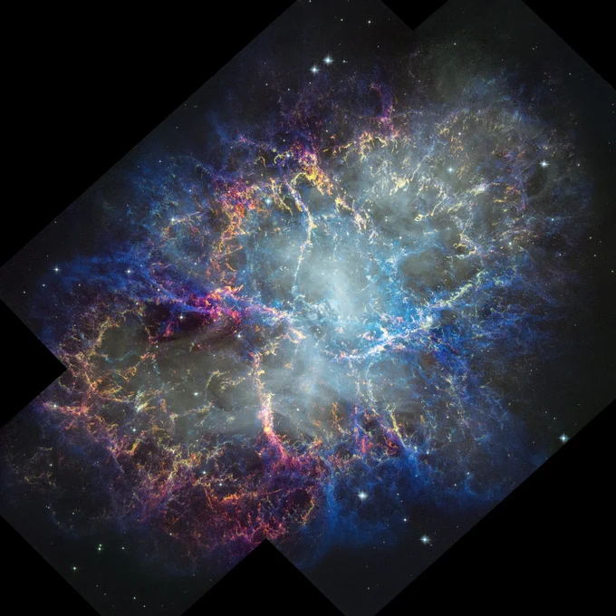 A colorful nebula in space with a white haze throughout that is more concentrated in the center with a rippling effect. Gas filaments appear to splash outward from the nebula center, colored yellow, magenta, and blue. A faint black border with right angles at the corners of the images show where the telescope\u2019s field of view stops. Small white stars dot the background. Credit: NASA, ESA, STScI, William Blair (JHU); Image Processing: Joseph DePasquale (STScI)