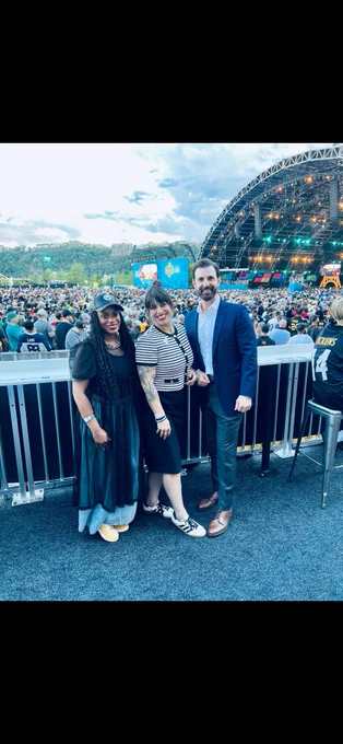 3 local electeds smiling overlooking the crowd at the Draft