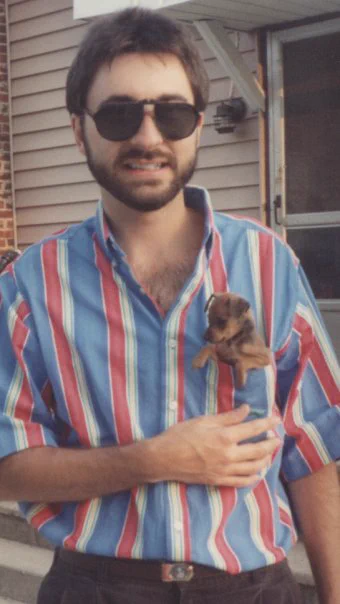 Sean Spence in 1995 with a Miniature Pinscher in pocket. Listen for these highlights Sunday on MAX 93.5 FM from 9am to Noon...
* A classical composer reacts to an Argent song "Hold Your Head Up"
* What's Alice Cooper up to?
* Highlighting the town of Montpelier with my story about their tall Indian
* A guy from Black Crowes explains "She Talks to Angels"

This show has a dog pic for the 2nd week in a row, Sunday mornings 9am to noon on radio, simulcast and streaming on MAXROCKS.NET AND posted there for 24 hours in the "Replay Any Hour" Podcast menu. Woof Boom!
