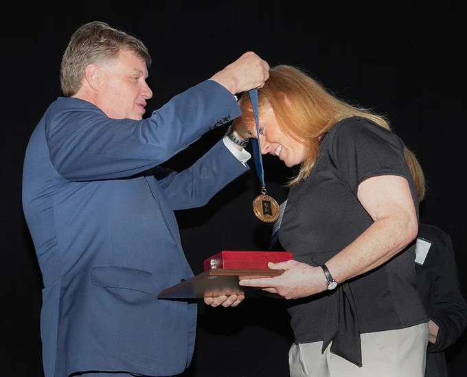 Dr. Anita Gaul and Chancellor Scott Olson being awarded.
