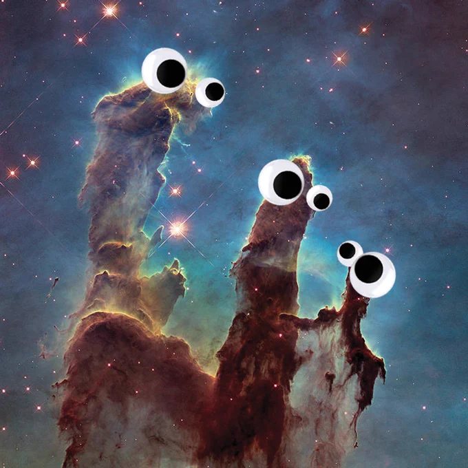 Hubble's iconic Pillars of Creation image showing three towering columns of dust and gas in the Eagle Nebula, with three pairs of googly eyes stuck on top of each pillar.
