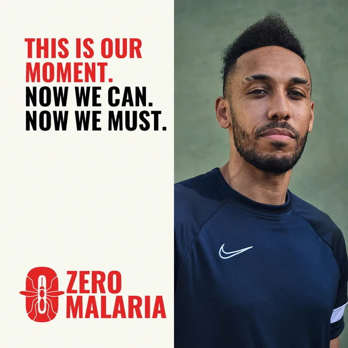 Pierre Aubameyang looks confidently down the camera. He wears a dark blue sports top. In red and black bold text, it reads: This is our moment. Now We Can. Now We Must. Zero Malaria. 