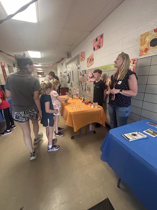 Adults and kids in a hallway