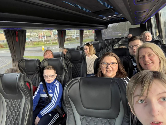 Young people and families from CoderDojo Banbridge sitting in a bus on the way down to Dublin