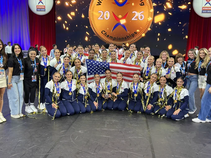 Texas Tech's Pom Squad posing with their world championship medals and the American flag.