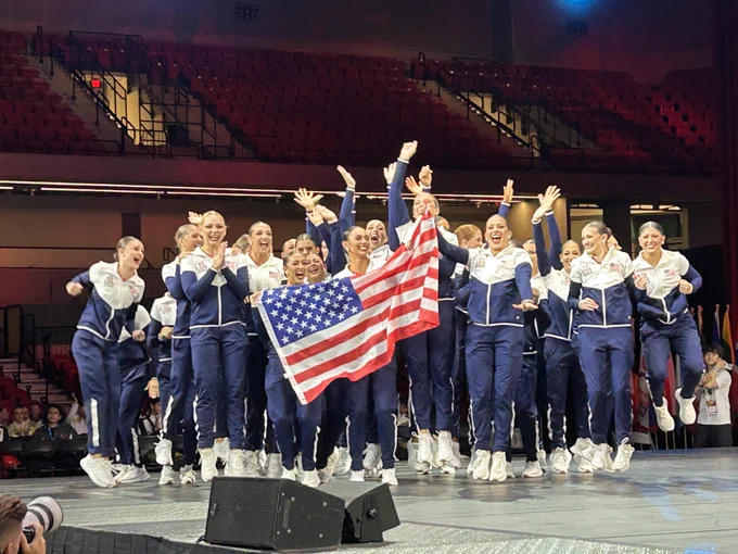 Texas Tech's Pom Squad waving to the crowd while holding the American Flag at the I-C-U World Championships.