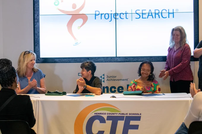 Students and staff applaud after two students signed with Project SEARCH at CTE Signing Day. 