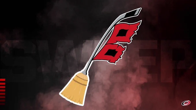 Photo of a broom with Hurricanes warning flags hanging off it with SWEEP in the background