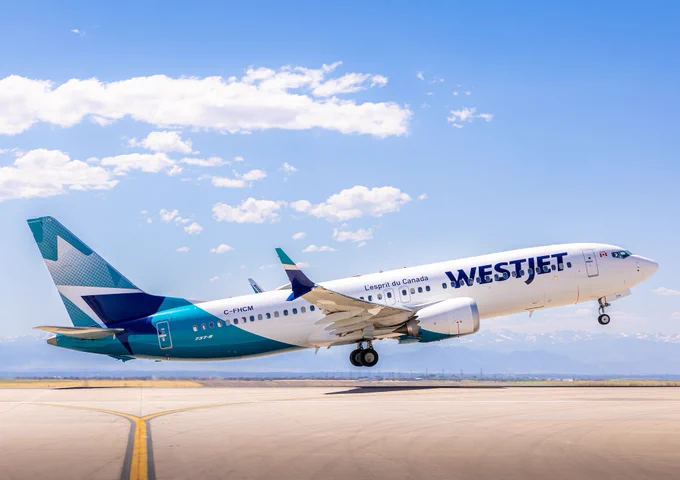 A WestJet airplane departs from DEN.