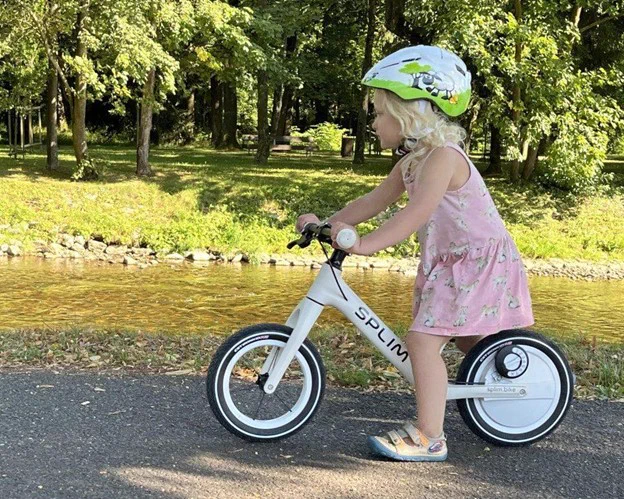 Little girl riding a small SPLIM bike.