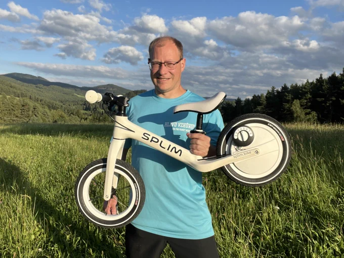 Jin Calta holding a SPLIM bike.