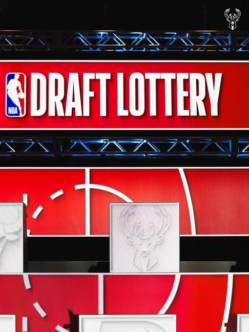 A photo of the NBA Draft Lottery stage in Chicago featuring a white Bucks logo.