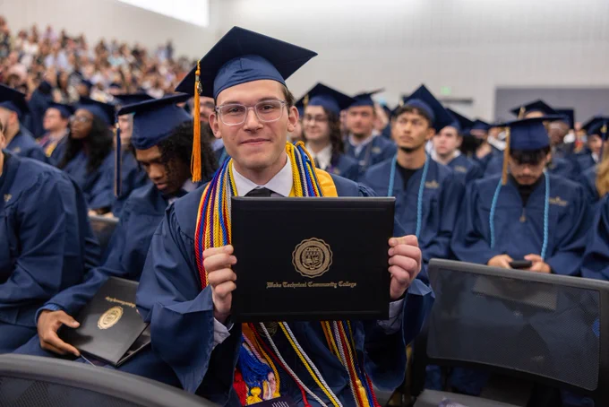 Wake Tech graduate Hani Safadi proudly displays his diploma.