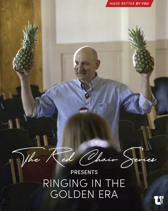 A person is standing in a room holding up two pineapples. They are facing an audience, some of whom are seated. The text on the image reads, "The Red Chair Series Presents Ringing in the Golden Era."