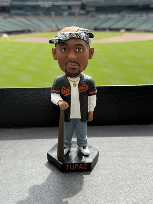 A Tupac Shakur bobblehead in an Orioles jersey