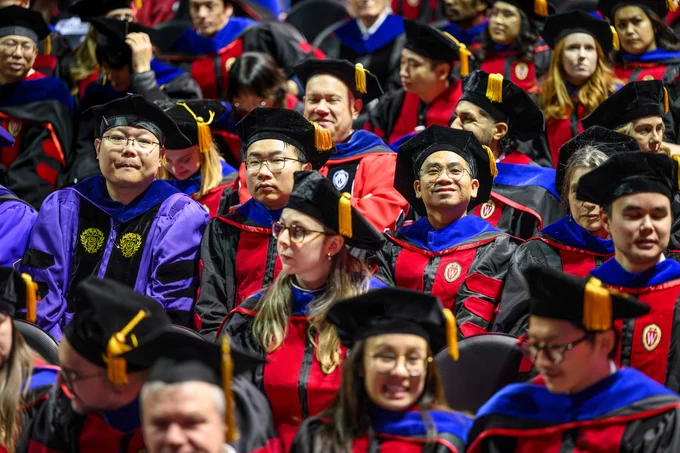 Doctoral graduates and their mentors in academic attire