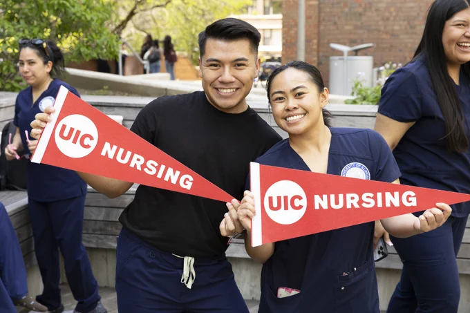 UIC Nursing students hold up pennants after taking the plunge.