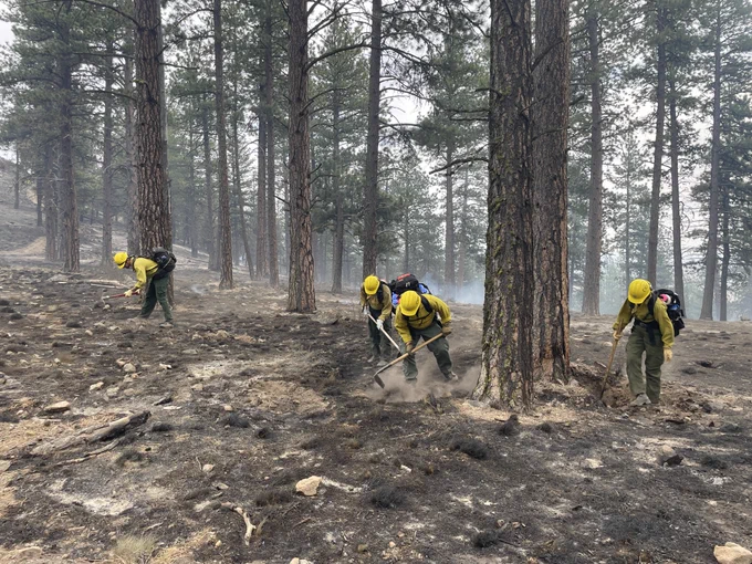 Firefighters mop up hot spots.