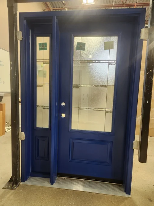 Custom blue entry door with decorative glass and sidelight built in Manitoba designed for energy efficiency and front entrance replacement.