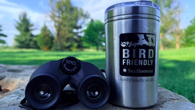 Image of a pair of binoculars and a metal coffee thermos with the "Smithsonian Bird Friendly" logo on it.