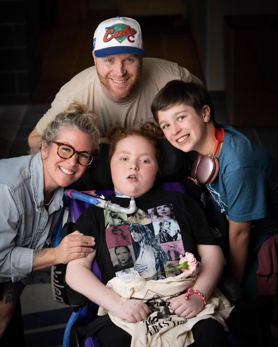 Four people posing and smiling.
