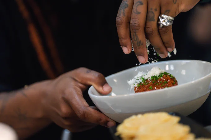 A chef preparing food during the Guest Chef series.