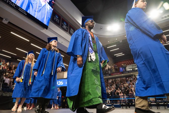 Graduates walking to seats.