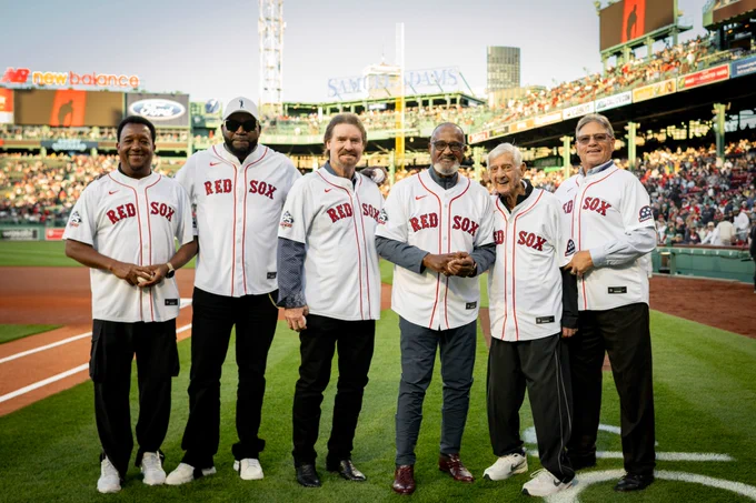 Pedro Martinez, David Ortiz, Wade Boggs, Jim Rice, Carl Yastrzemski and Carlton Fisk pose for a photo on the field at Fenway Park wearing the Red Sox home white jerseys.