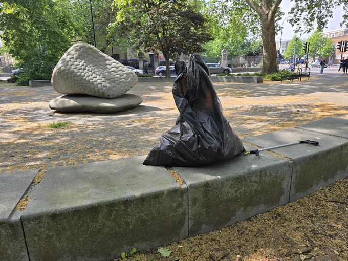 Large black bag full of litter collected in Oval Triangle.