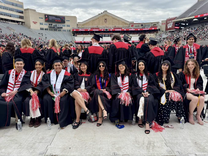 A row of graduates wearing their regalia at Camp Randall.