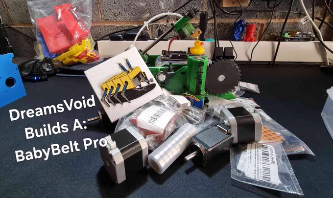 A pile of 3d printer components including nema17 motors, nema11 motors and packets of screws. Balanced on top is an original BabyBelt 3d printer 