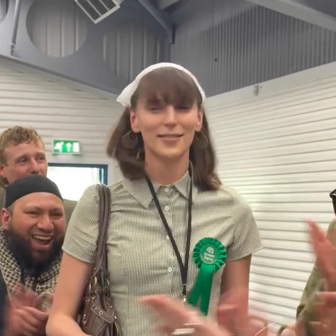 Mothin Ali laughing and clapping beside Eden Hills at the announcement of her victory