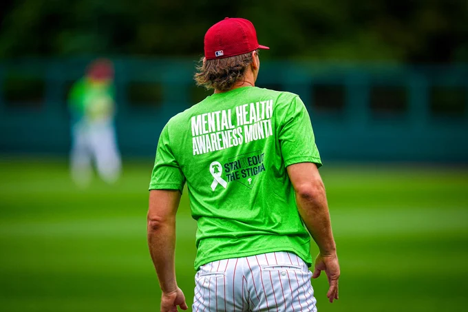 The Phillies are pictured at BP wearing green shirts for Mental Health Awareness