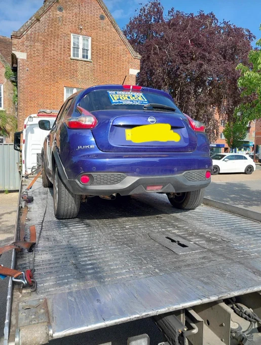 Seized Nissan Juke on recovery truck after being found to have no tax or insurance