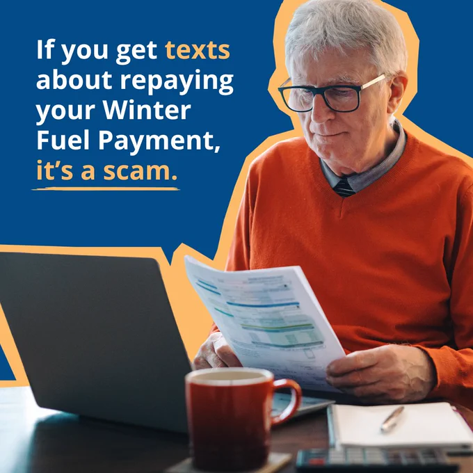 An individual wearing glasses is looking at a paper while sitting at a desk with a laptop and a mug. Text on the image warns about scams related to Winter Fuel Payment repayment texts.