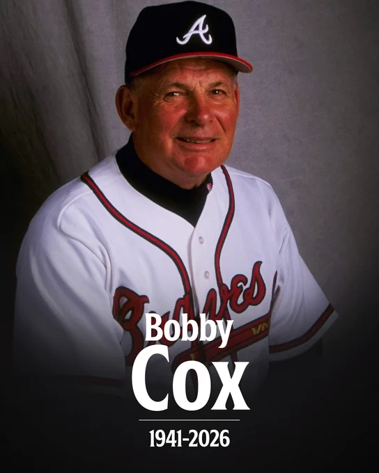Bobby Cox
1941-2026
Bobby Cox smiles while wearing a home white Atlanta Braves uniform and dark blue Atlanta Braves cap.