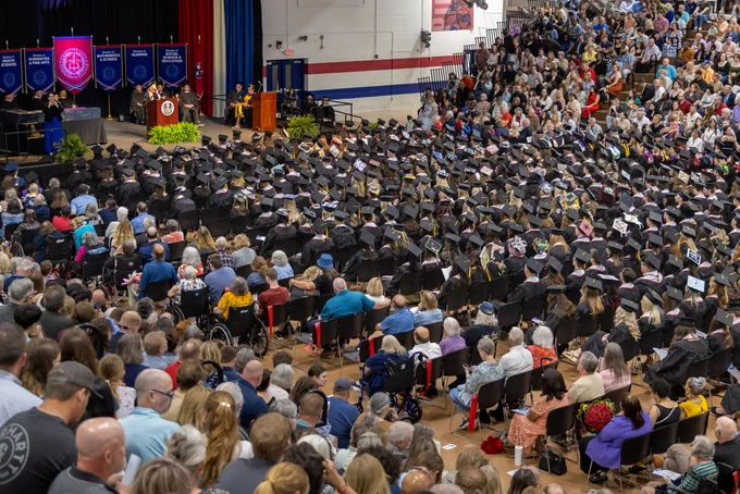 Image overlooks the Pickel Fieldhouse (Gym), looking down onto the graduates and stage.