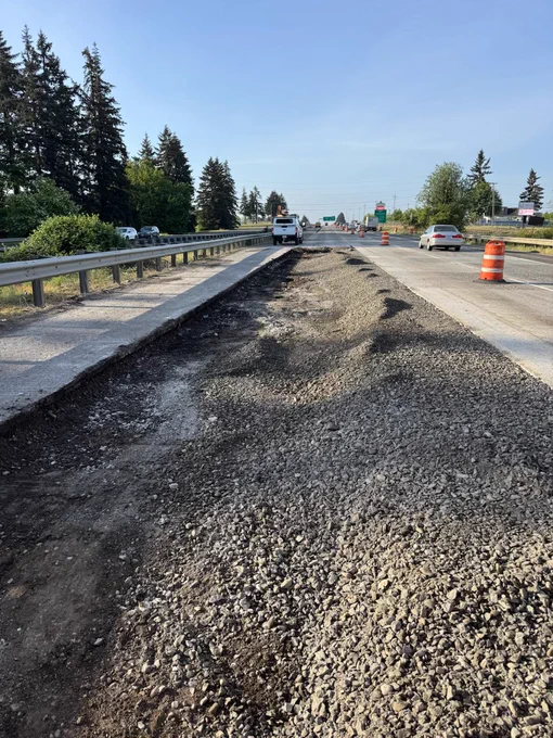 Photo shows pavement which was broken down into small gravel sized pieces. These pieces are reused as the base under the travel lanes of the highway.