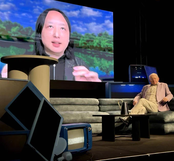 Audrey Tang (on screen), Taiwan’s cyber ambassador, first digital minister, architect of the Taiwan Model for digital diplomacy and 2025 Right Livelihood laureate, discusses radical trust with Toby Walsh (on stage), laureate fellow and scientia professor of artificial intelligence at the University of New South Wales, during the Action and Wisdom Forum opening conversation in Melbourne, Australia.