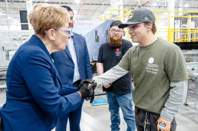 Rep Kaptur shaking hands with an employee at First Solar's factory in Ohio.