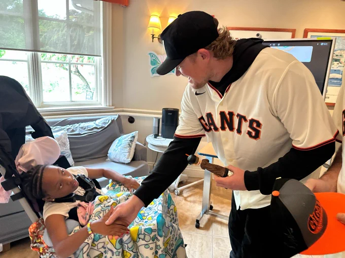 Webb shaking a child’s hand