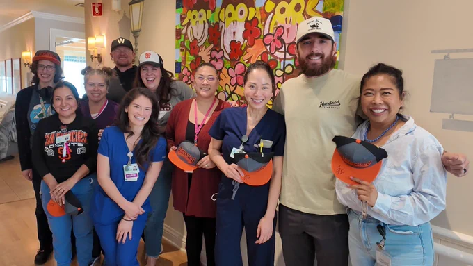 Webb and Walker posing for a photo with staff