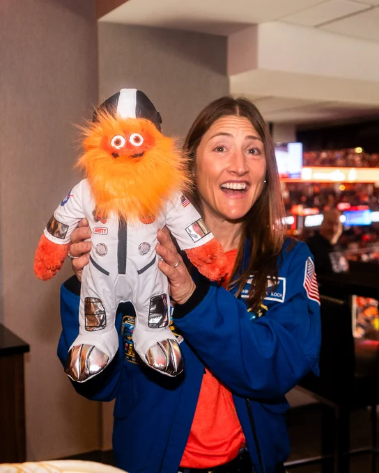 Christina Koch at Game 4 in Philadelphia holding a toy Gritty. 